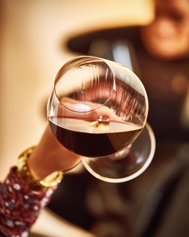 Zalto Burgundy glass with red wine held in a hand